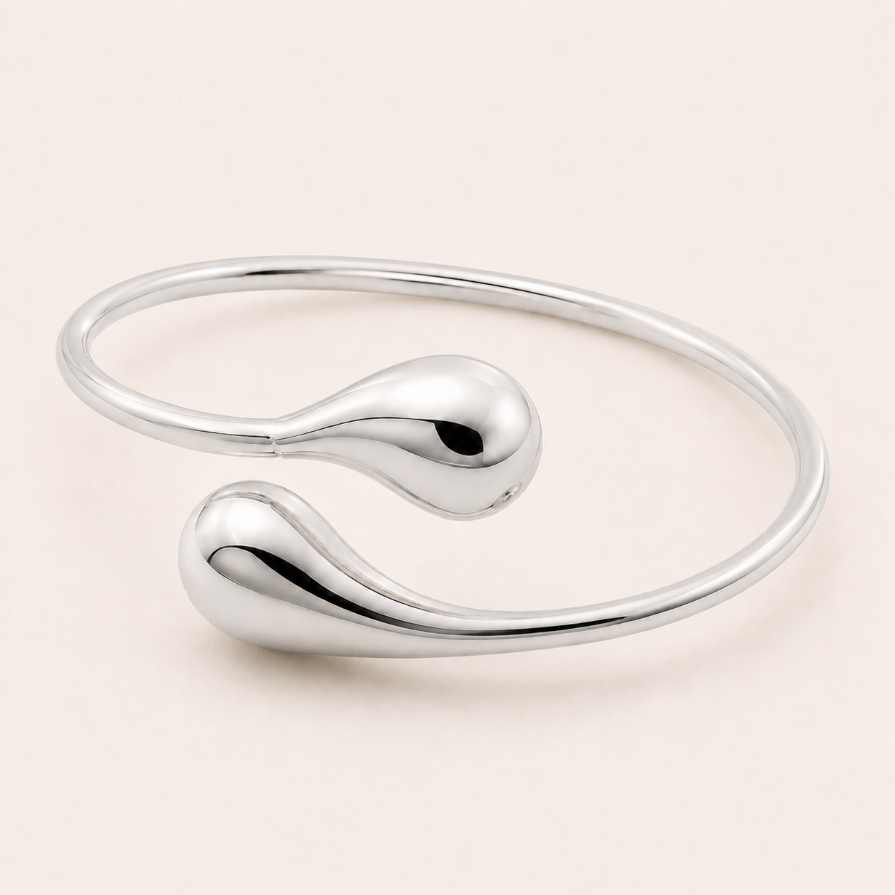 Silver bangle on a light beige background